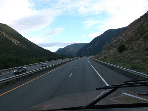 2009 Kenworth T800 - Driving on a highway surrounded by mountains under a partly cloudy sky.