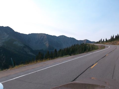 2009 Kenworth T800 - A scenic view of a winding road through a mountainous landscape under a clear sky.