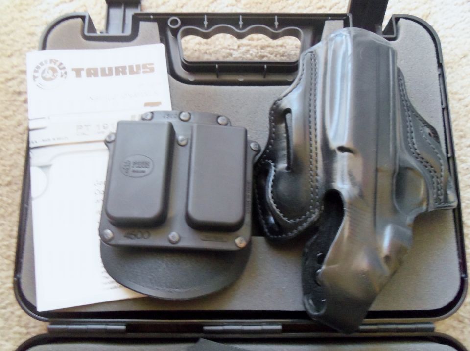 Taurus pistol in hard case with black leather holster, magazine pouch and manual