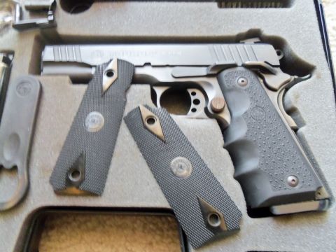 2000 Mercury Grand Marquis - A pistol with textured grips and detached grip panels is shown in a fitted case.