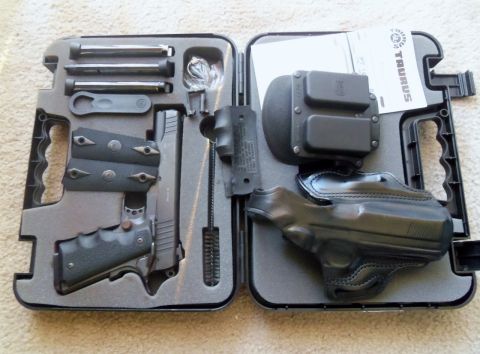 2000 Mercury Grand Marquis - A pistol with accessories, including magazines, a holster, and cleaning tools, is neatly organized within a fitted carrying case.
