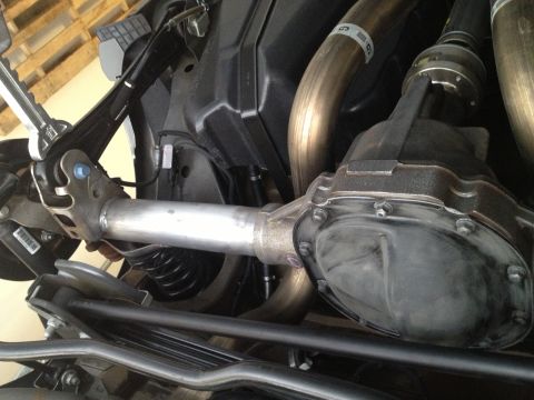 2013 Ford Mustang - Close-up view of a vehicle's rear axle and exhaust system components.