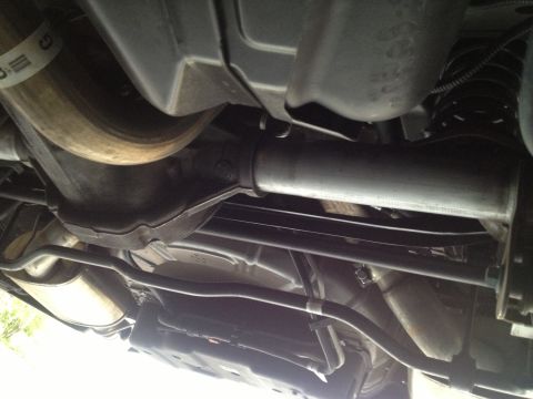 2013 Ford Mustang - Underside view of a 2013 Ford Mustang, highlighting the exhaust system and rear suspension components.