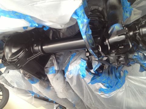 2013 Ford Mustang - Underside of a vehicle's rear axle and driveshaft, covered for protection.