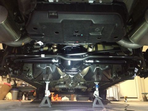 2013 Ford Mustang - Underbody view of a 2013 Ford Mustang, highlighting the rear axle and dual exhaust system.