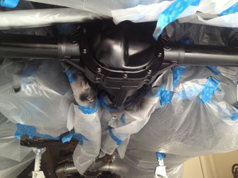 2013 Ford Mustang - Rear differential assembly is covered in plastic wrap and tape, likely for painting or protection.