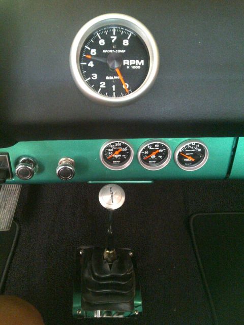 1971 Ford Ranchero - Close-up of the interior dashboard, showing various gauges and a manual transmission shifter.