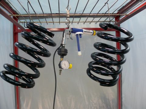 1976 Chevrolet Corvette - Coil springs are being powder coated in a spray booth with specialized equipment.