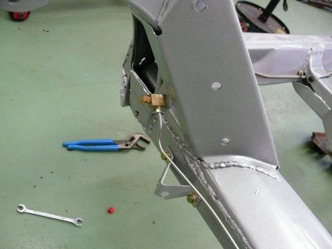 1976 Chevrolet Corvette - Car frame detail with brake line and tools visible, likely during restoration or repair.
