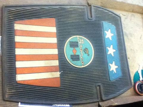1995 Ford Bronco - A vintage Ford Bronco floor mat features a patriotic design with red and white stripes and a blue section with three white stars.