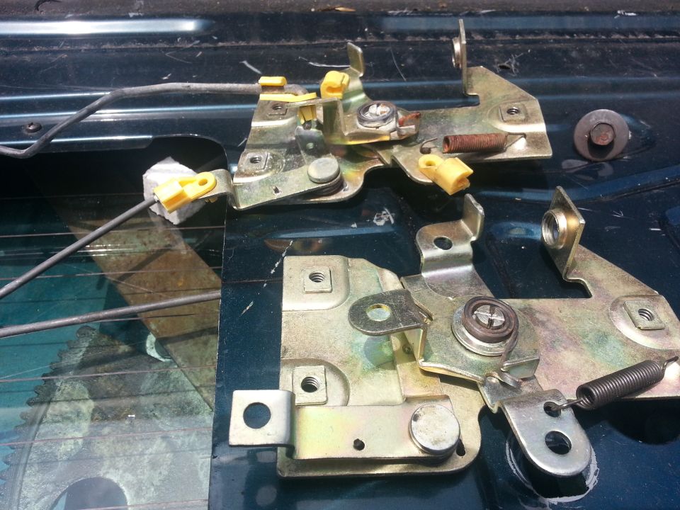 Tailgate latches with yellow plastic clips and springs