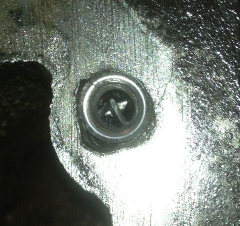 1978 Ford Bronco - A close-up view of a spark plug, likely from an engine component.