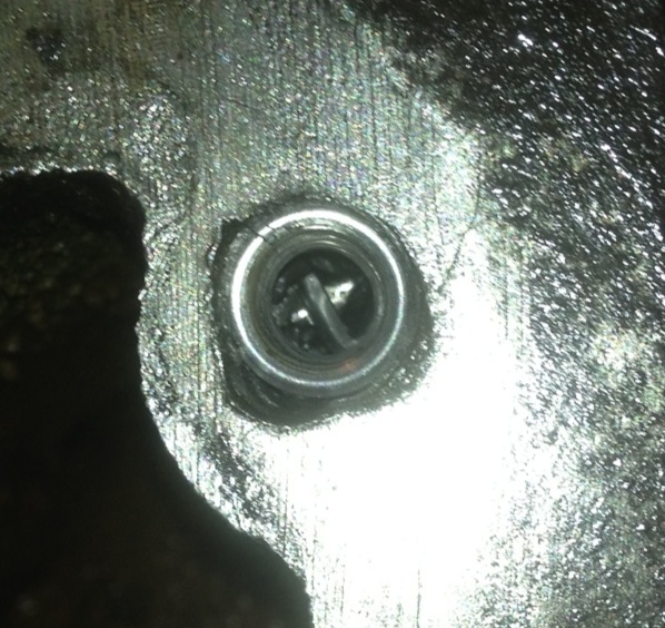 Spark plug in a metal surface