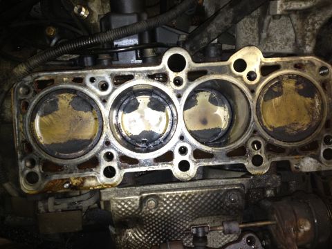 1989 Ford Bronco - Close-up view of an engine's cylinder head, revealing the condition of the pistons within the cylinders.
