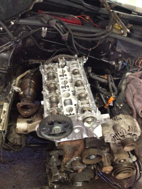 1989 Ford Bronco - Close-up view of disassembled engine components, including the camshaft and timing gears.