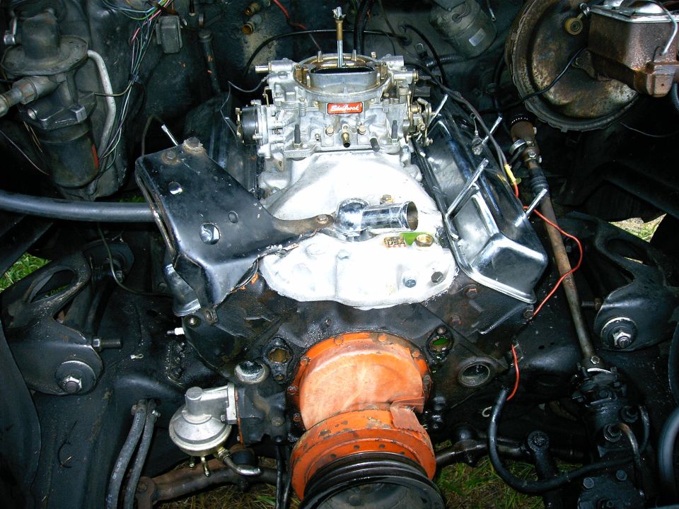 V8 engine with Edelbrock carburetor and chrome valve covers. Fuel pump visible