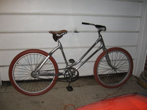 1994 Ford Bronco - A custom-built bicycle with a unique frame design and vintage-inspired components is shown in a garage.