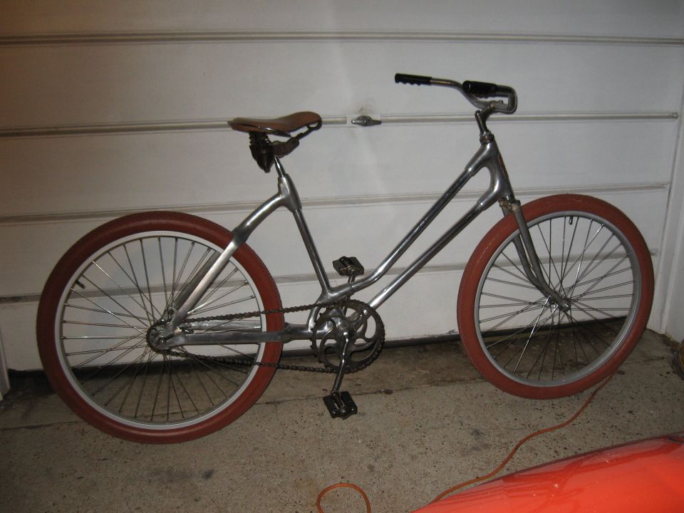 Custom bicycle with silver frame and red tires