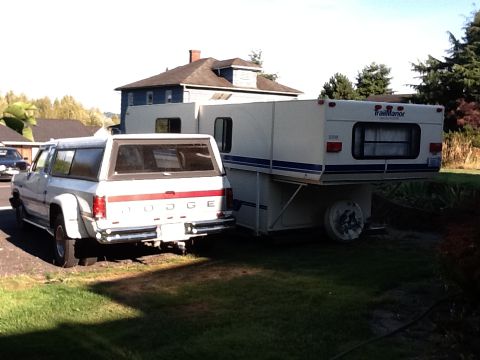 1988 Suzuki Samurai - A Dodge pickup truck tows a Trailmanor camper. The truck appears to be from the late 1980s.