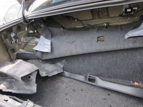 2001 Ford Crown Victoria - The trunk of a 2001 Ford Crown Victoria is shown with its interior components exposed after the removal of carpeting and trim.