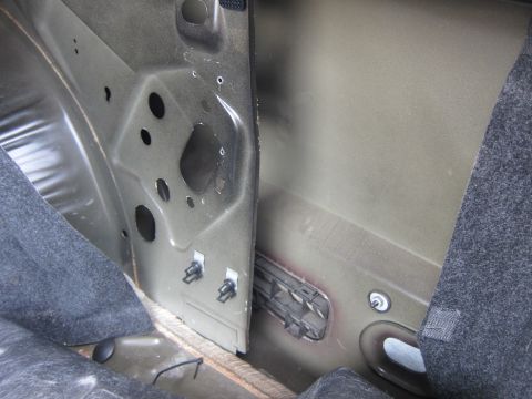 2001 Ford Crown Victoria - Close-up view of the interior structure of a car's trunk area.