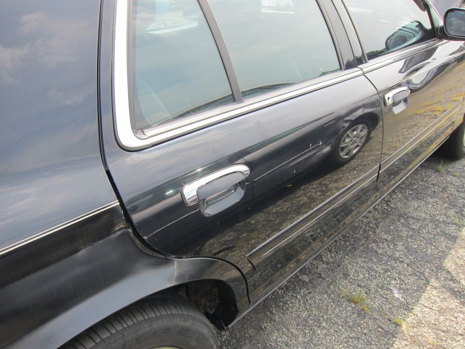 Side view of a black 2001 Ford Crown Victoria with chrome trim and door handles