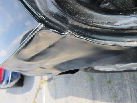 2001 Ford Crown Victoria - Damaged car door edge shows significant deformation and paint damage.