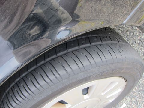 2001 Ford Crown Victoria - A close-up view of a car's tire and fender shows the 'GOODYEAR' branding on the tire.