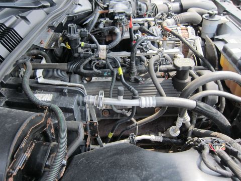 2001 Ford Crown Victoria - Close-up view of a car's engine bay, showing various mechanical parts and wiring.