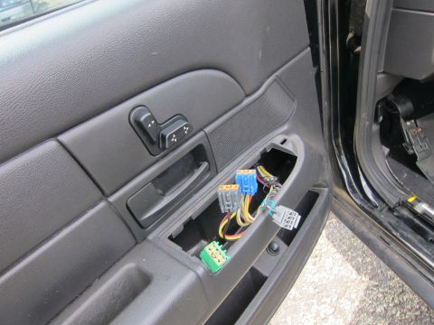 2001 Ford Crown Victoria - The driver's side door panel shows exposed wiring and connectors where the trim has been removed.