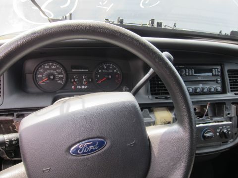 2001 Ford Crown Victoria - Interior view of a 2001 Ford Crown Victoria, showing the steering wheel, instrument cluster, and radio.