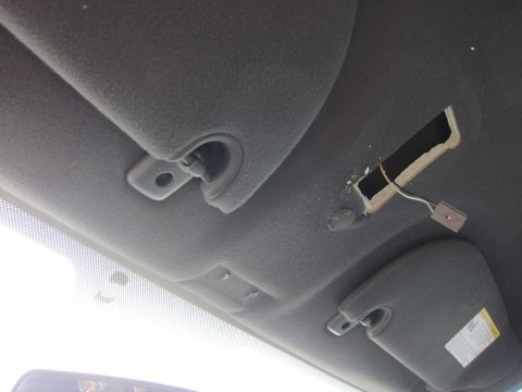 2001 Ford Crown Victoria - Damaged car ceiling panel reveals exposed wiring and connector.