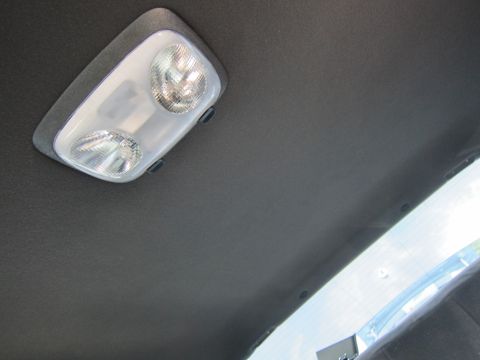 2001 Ford Crown Victoria - The overhead interior light fixture of a vehicle is shown, with a dark headliner surrounding it.