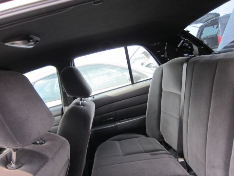 2001 Ford Crown Victoria - Interior view of a car, showing the back seats and headrests, with other vehicles visible outside.