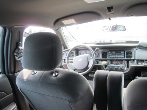 2001 Ford Crown Victoria - The interior of a Ford Crown Victoria shows a disassembled dashboard and steering wheel.