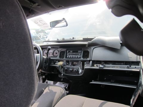 2001 Ford Crown Victoria - The interior of a 2001 Ford Crown Victoria shows a disassembled dashboard and gray seats.
