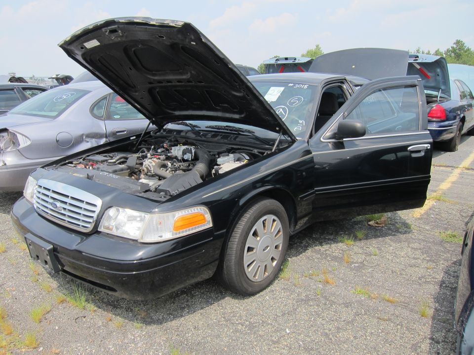 Black 2001 Ford Crown Victoria with hood and door open, showing engine. Front 3/4 view