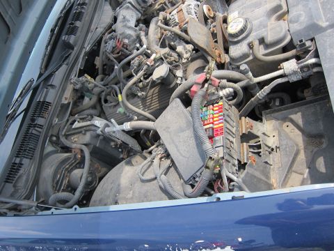 2001 Ford Crown Victoria - The engine bay of a 2001 Ford Crown Victoria, showing various components and wiring.