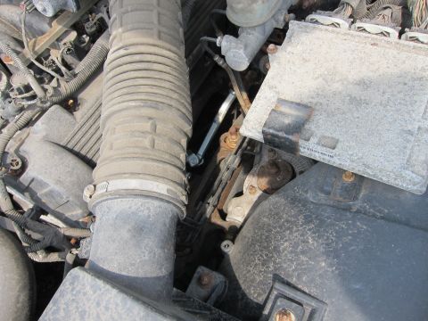 2001 Ford Crown Victoria - A close-up view of a vehicle's engine compartment shows various components and wiring harnesses.