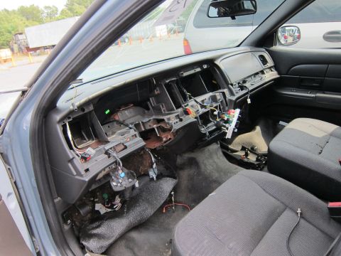2001 Ford Crown Victoria - Interior view of a 2001 Ford Crown Victoria with the dashboard disassembled, revealing wiring and internal components.