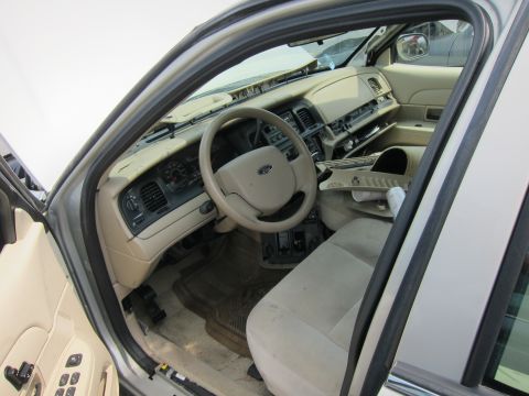 2001 Ford Crown Victoria - The interior of a car is shown with parts removed from the dashboard and door panels.