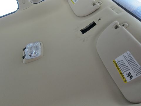 2001 Ford Crown Victoria - Interior view of the vehicle's ceiling, showing sun visors and a dome light.