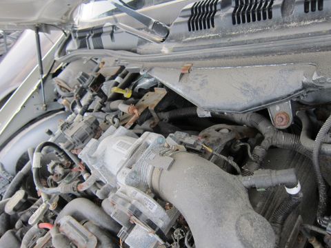 2001 Ford Crown Victoria - Close-up view of the engine compartment, highlighting the complex network of wires and components.