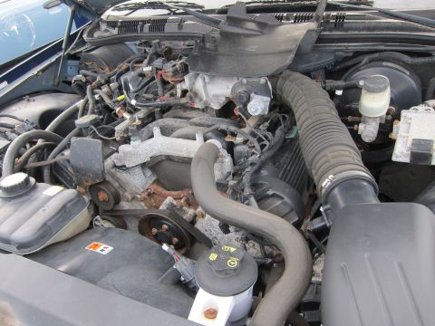 2001 Ford Crown Victoria - Engine bay of a 2001 Ford Crown Victoria, showing the V8 engine and associated components.