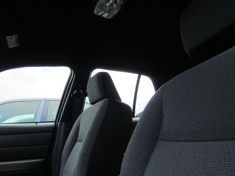 2001 Ford Crown Victoria - The interior of a car is shown, with a view of the front seats and a glimpse of another vehicle outside.