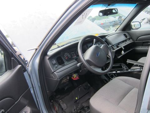 2001 Ford Crown Victoria - The interior of a 2001 Ford Crown Victoria is visible, with the dashboard and steering wheel in view.