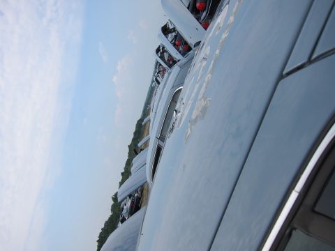 2001 Ford Crown Victoria - Multiple vehicles lined up, seen from a side angle under a cloudy sky.