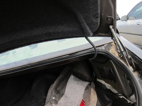 2001 Ford Crown Victoria - Interior view of the open trunk of a 2001 Ford Crown Victoria, with another vehicle visible in the background.