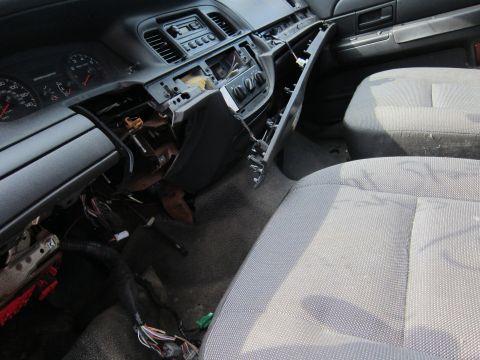 2001 Ford Crown Victoria - The interior of a 2001 Ford Crown Victoria shows a disassembled dashboard with exposed wiring.