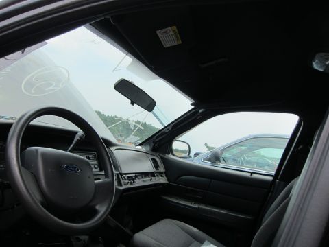 2001 Ford Crown Victoria - The interior of a 2001 Ford Crown Victoria is seen from the passenger side, with another vehicle visible outside.